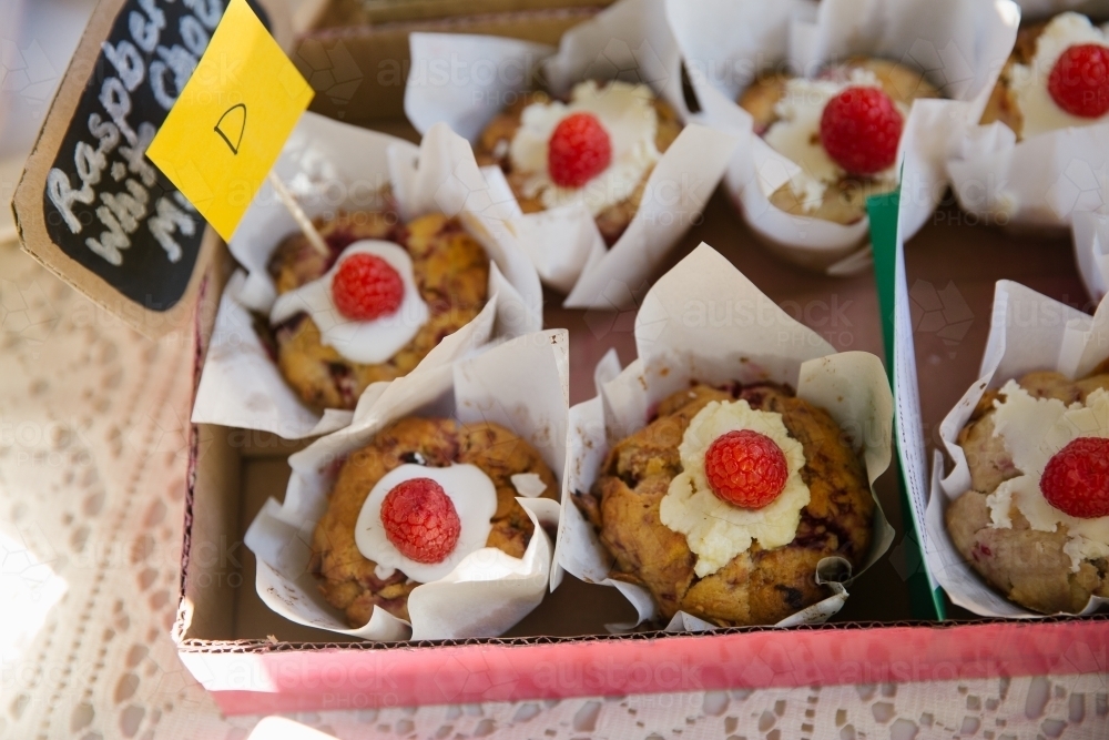 Close up shot of raspberry with chocolate muffins in a pink box - Australian Stock Image