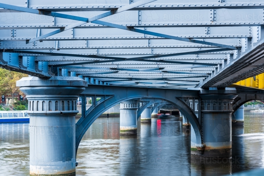 Close-up shot of the bottom of the bridge on the river - Australian Stock Image
