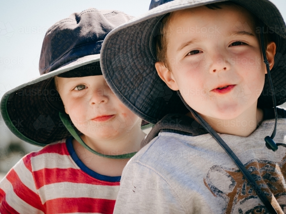 Close up to two boys, little mates looking at camera - Australian Stock Image