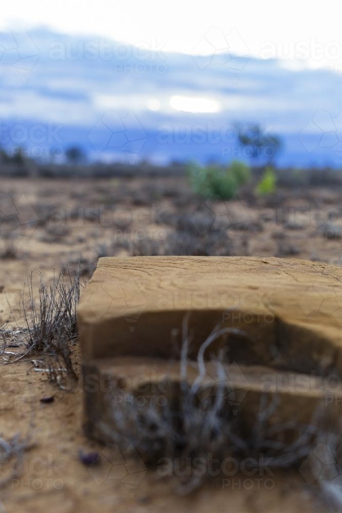 Close up view of weathered rock and dry grass in remote location - Australian Stock Image