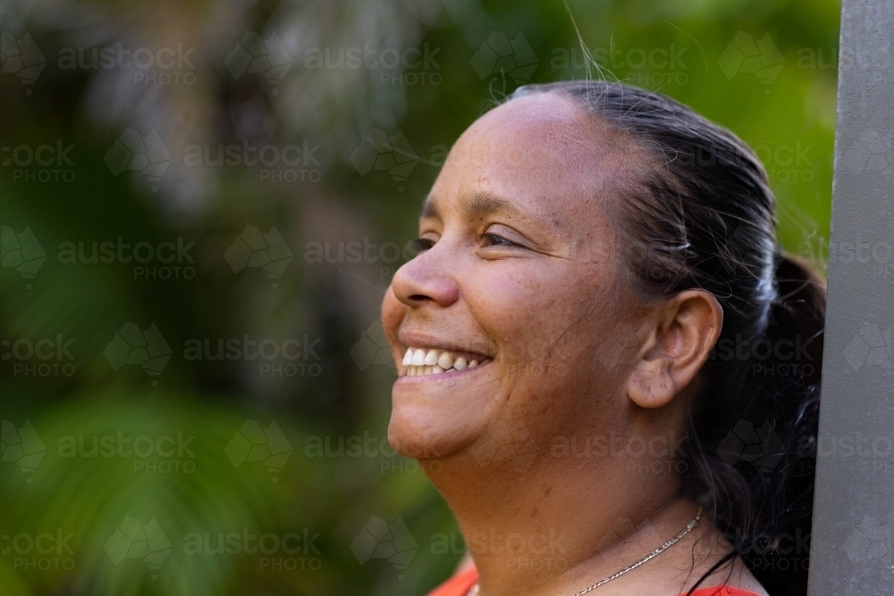 close view of indigenous woman smiling and looking away - Australian Stock Image