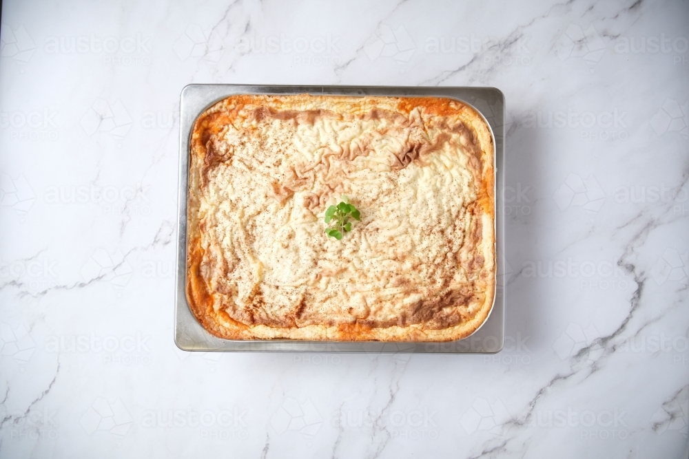 closeup of a baked dish on a marble counter - Australian Stock Image