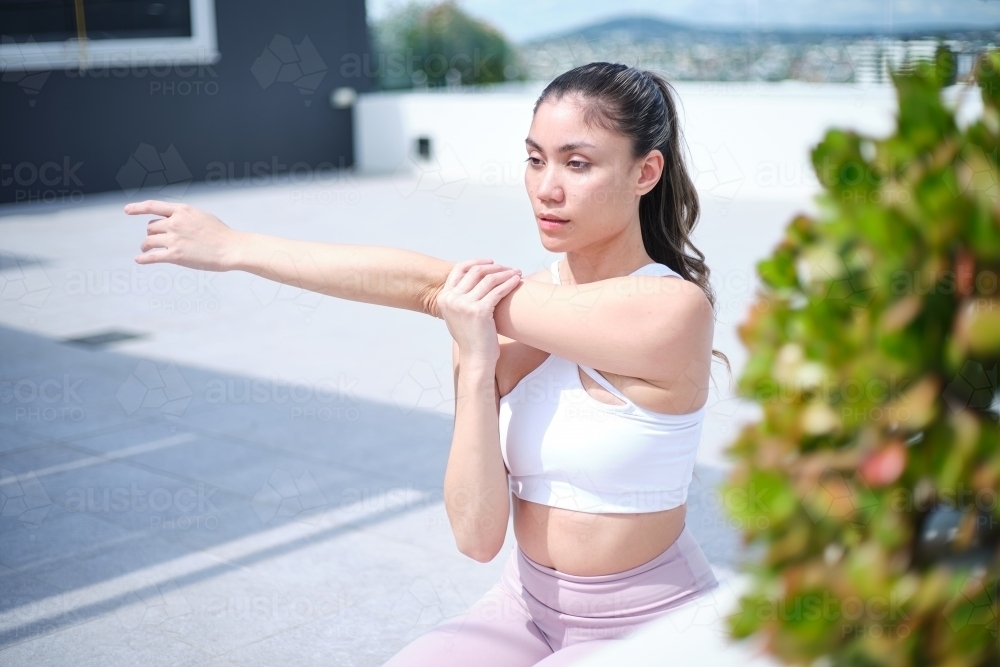 closeup of a woman doing yoga poses outdoors - Australian Stock Image