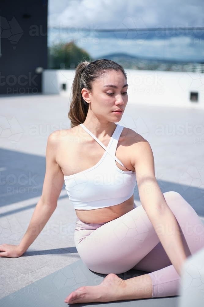 closeup of a woman doing yoga poses outdoors - Australian Stock Image