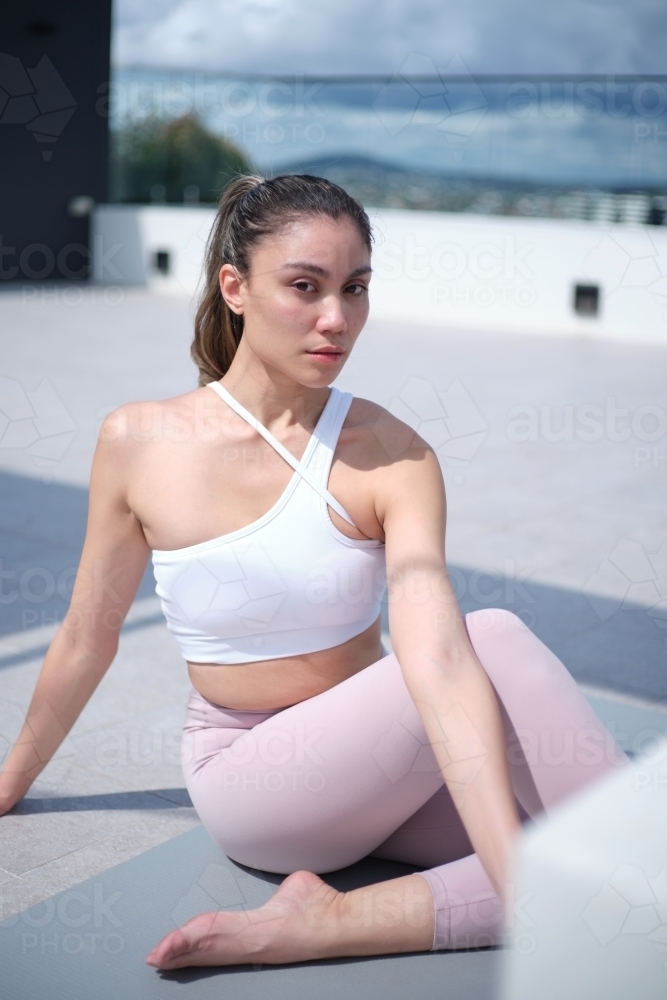 closeup of a woman doing yoga poses outdoors - Australian Stock Image