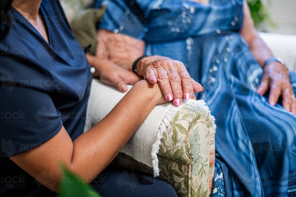 Image of Closeup of elderly womans hand resting on top of caregivers ...