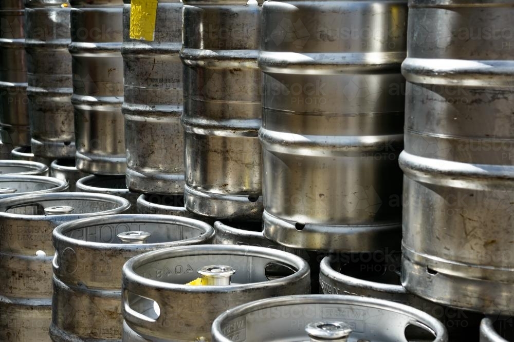 Image of Closeup of metal beer kegs stacked in rows Austockphoto
