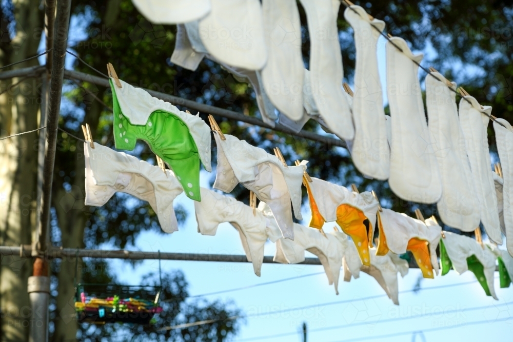 Cloth nappies hanging on clothes line. - Australian Stock Image