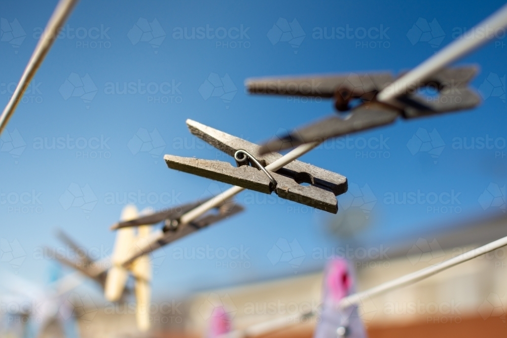 Clothesline Pegs hanging on a sunny morning - Australian Stock Image