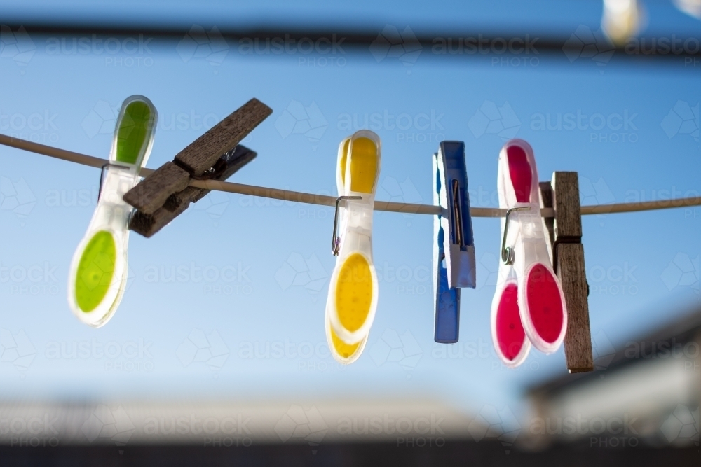 Clothesline Pegs hanging on a sunny morning - Australian Stock Image