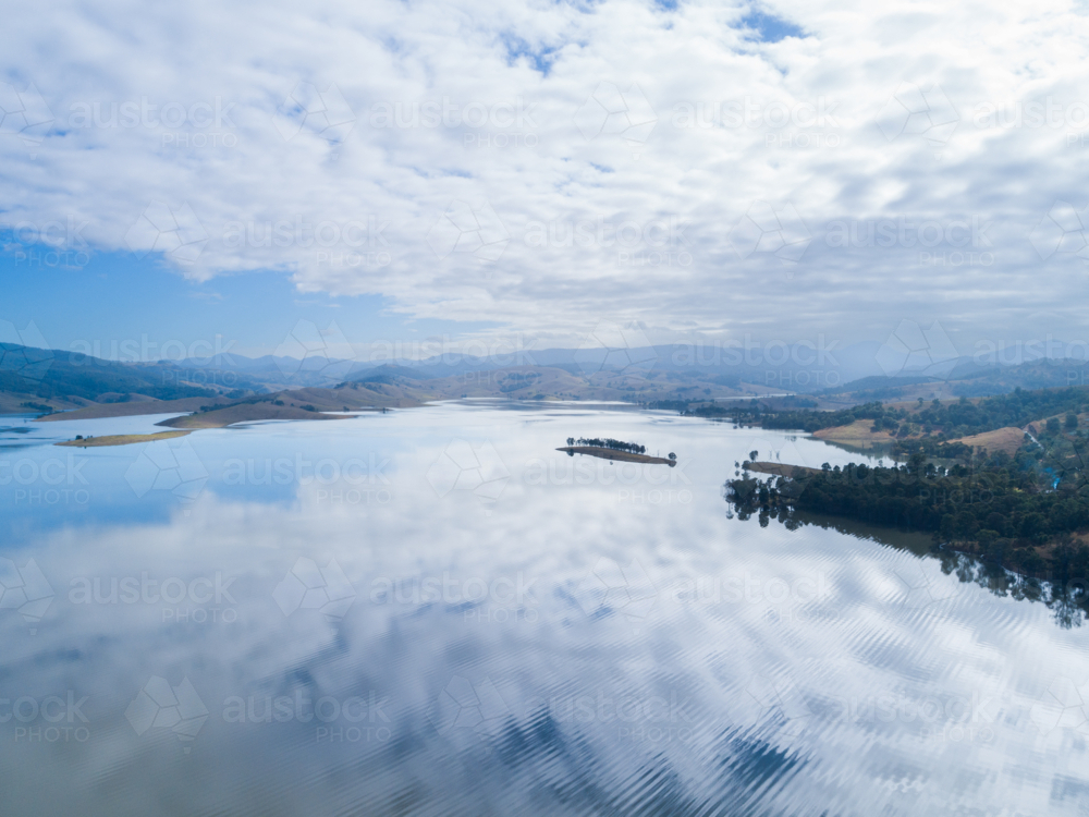 Clouds and sky reflecting in waters of lake in the Hunter Valley, NSW, Australia - Australian Stock Image