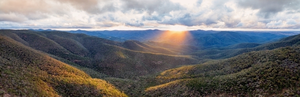 Clouds and sunrise over valleys and mountains - Australian Stock Image