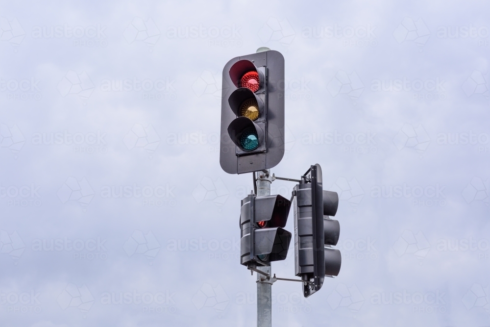Cloudy sky background traffic lights - Australian Stock Image