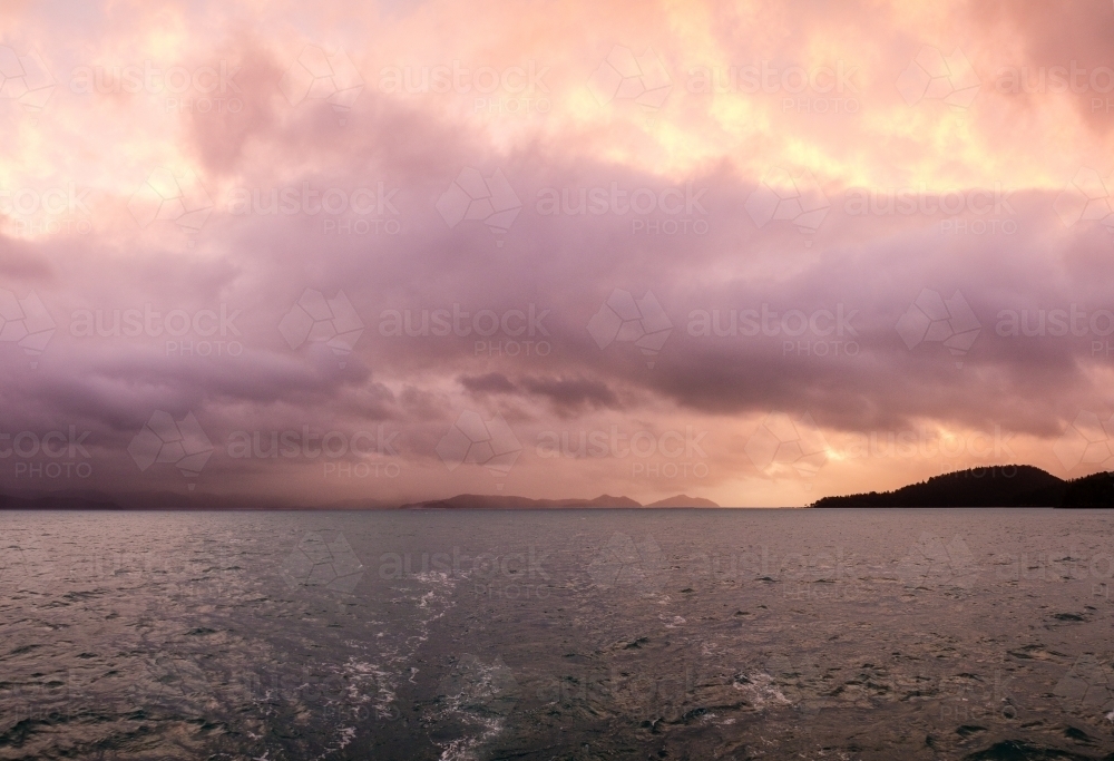 cloudy sunset over water - Australian Stock Image
