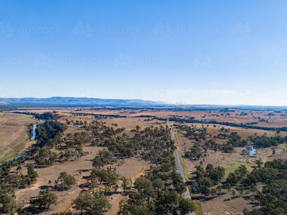 Coal dust cloud on horizon from distant mine blasting - Australian Stock Image