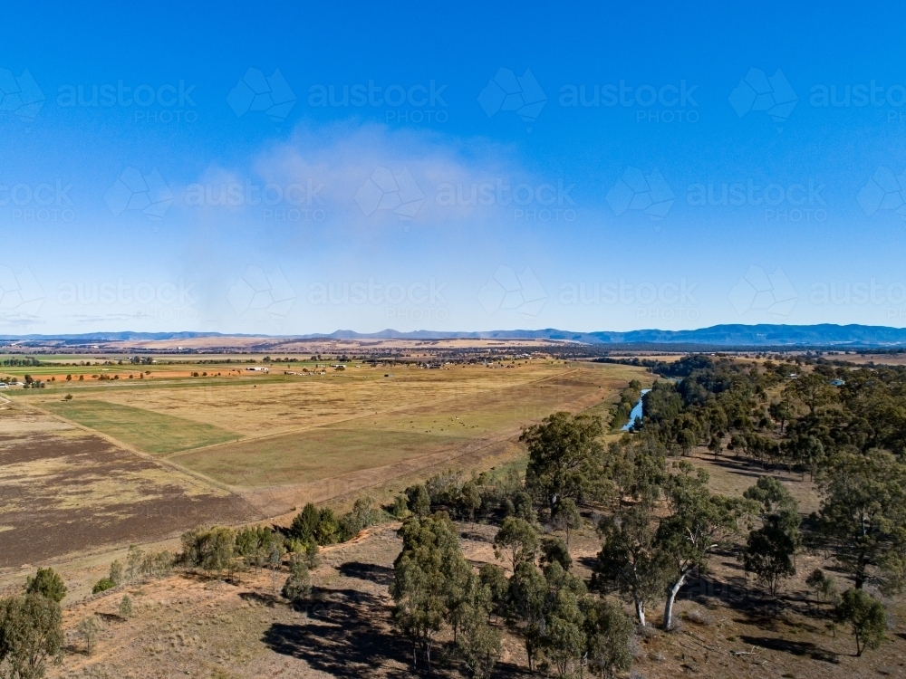 Coal dust cloud on horizon from distant mine blasting - Australian Stock Image