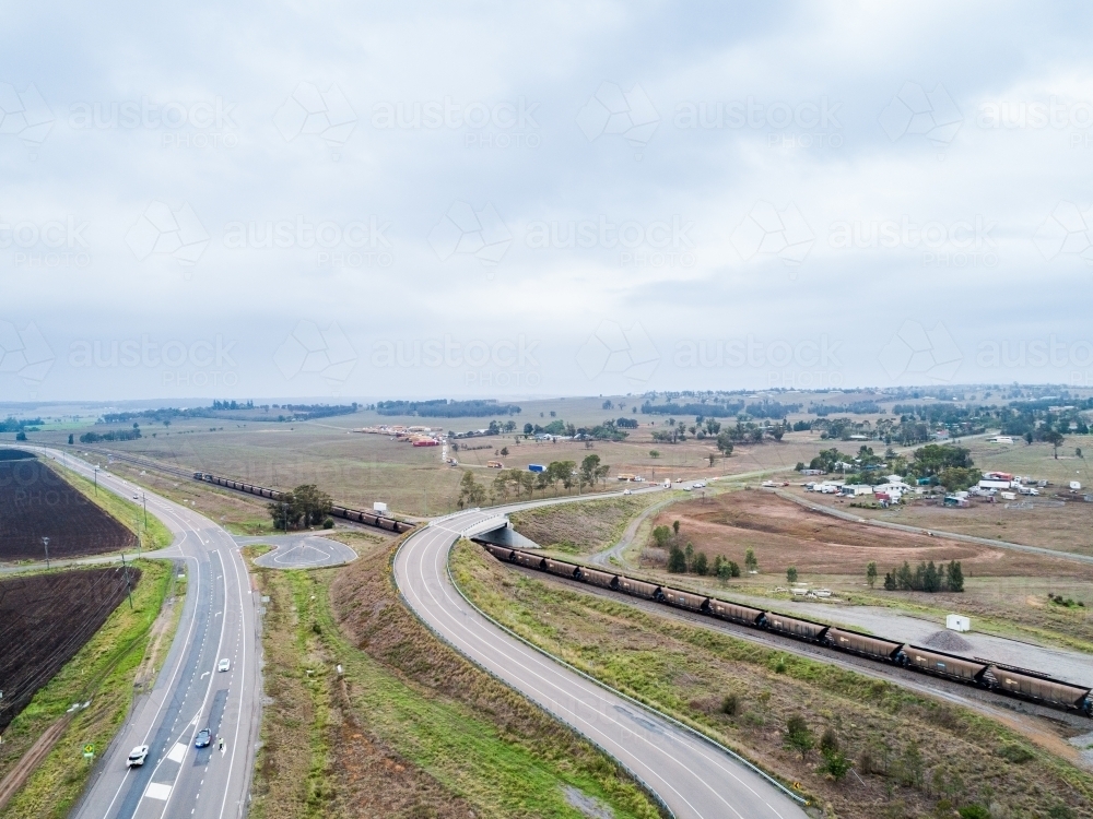 coal train going under overpass in countryside in Hunter Valley near Singleton - Australian Stock Image