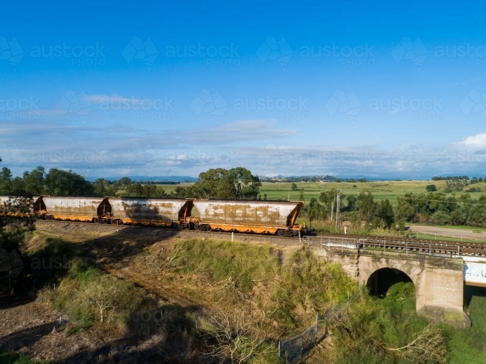 Image of coal train on railway track bridge at the edge of Singleton a ...