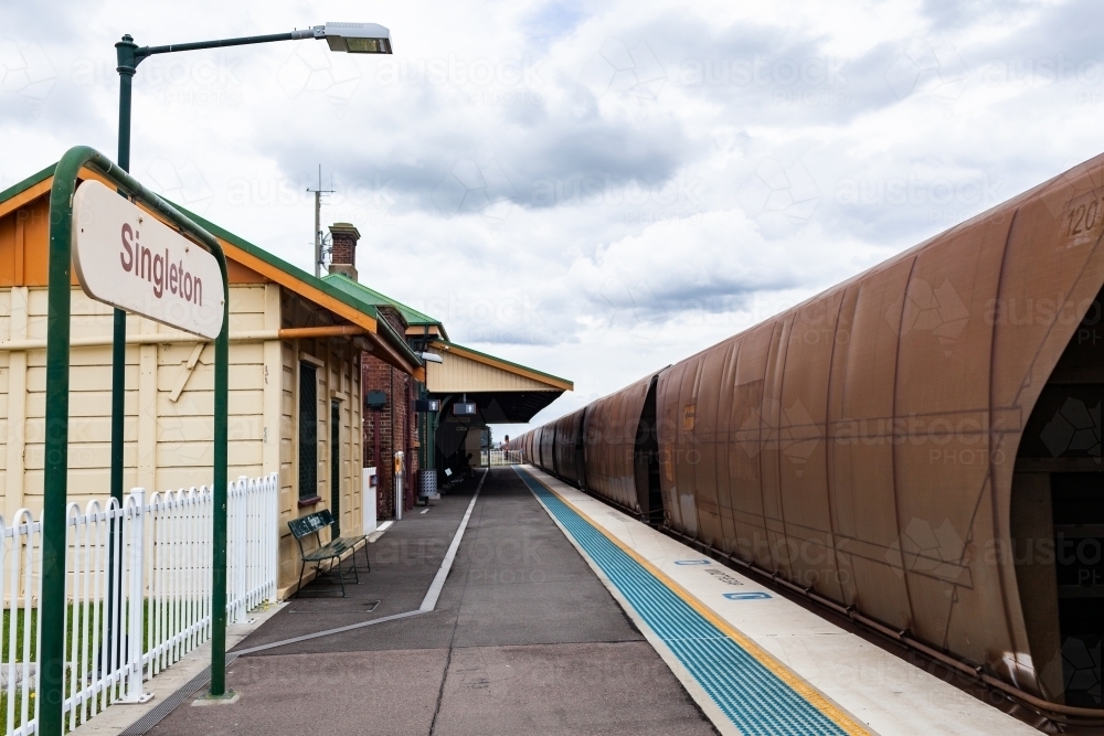 Image of Coal train passing singleton train station railway platform on ...