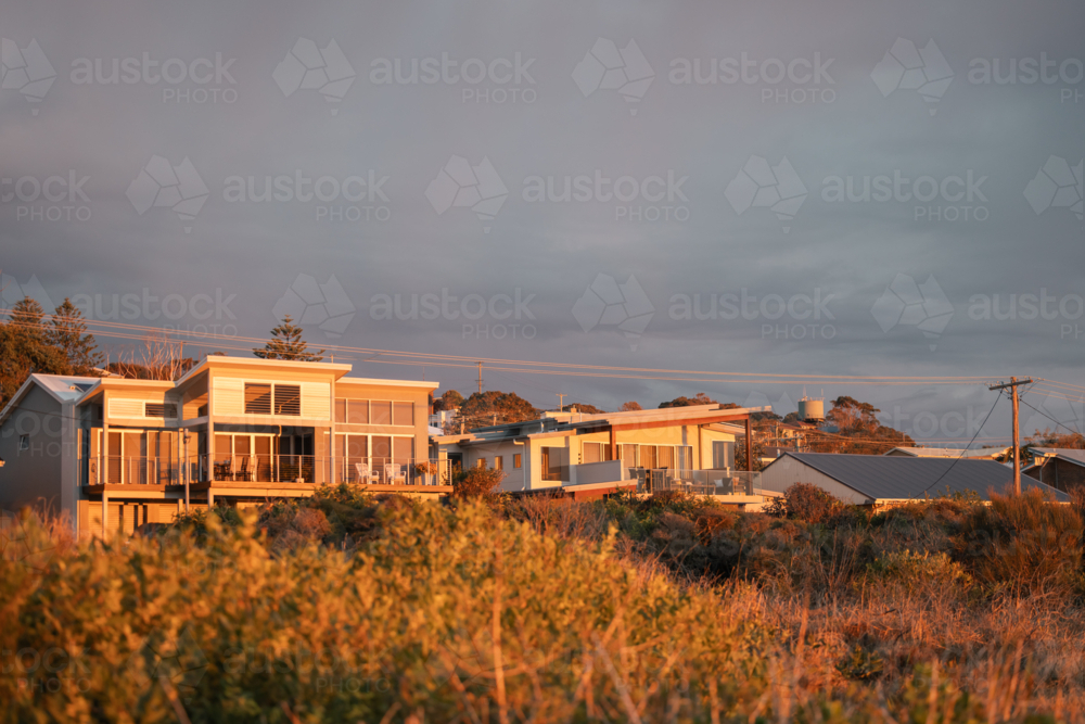 Coastal homes bathed in early morning light - Australian Stock Image