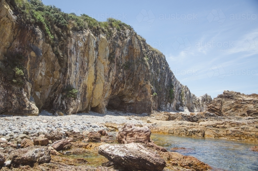 Coastal landscape with sea caves - Australian Stock Image