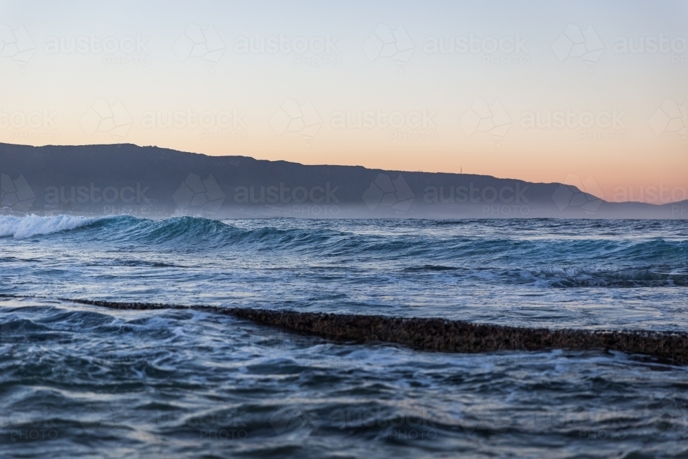 Coastal scene with waves at dusk - Australian Stock Image