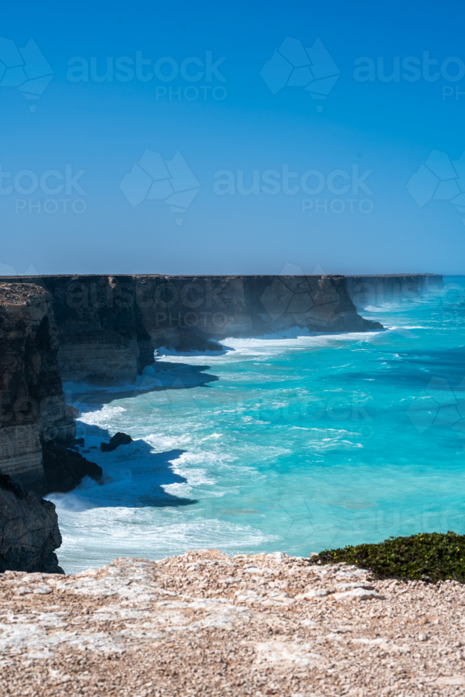 Coastal vista of towering, rugged cliffs in an open sea. - Australian Stock Image
