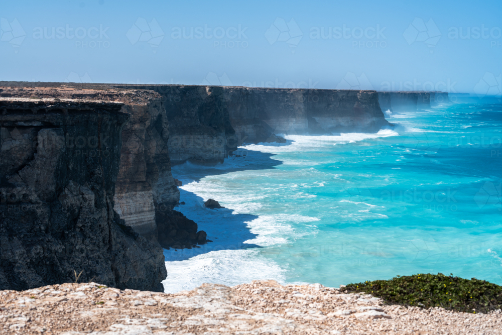 Coastal vista of towering, rugged cliffs in an open sea. - Australian Stock Image