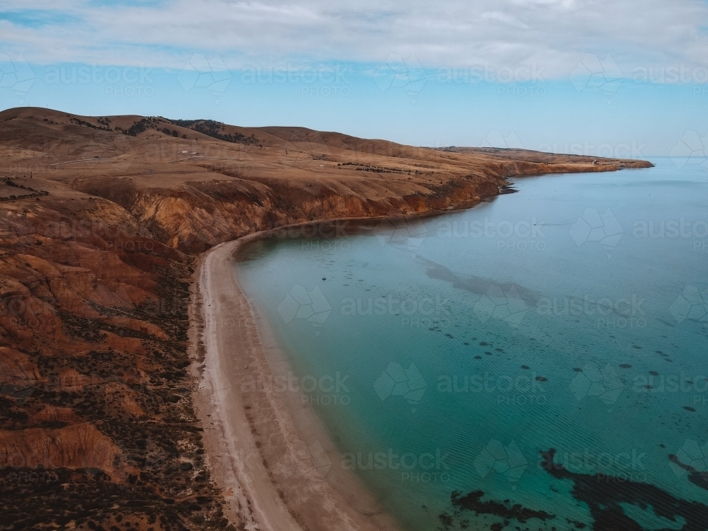 Coastline with rolling hills and calm blue ocean - Australian Stock Image