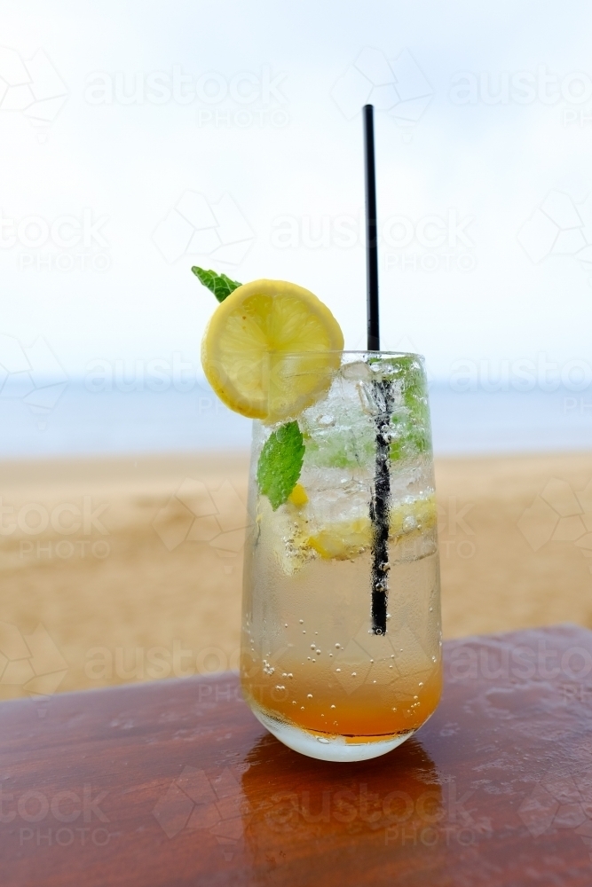 Cocktail drink on a table by the beach - Australian Stock Image