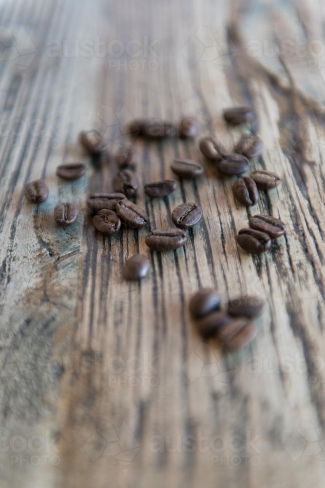 Coffee beans with wood grain table background - Australian Stock Image