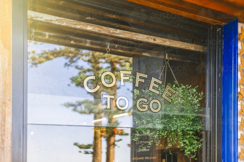 Coffee shop window with reflection of trees - Australian Stock Image