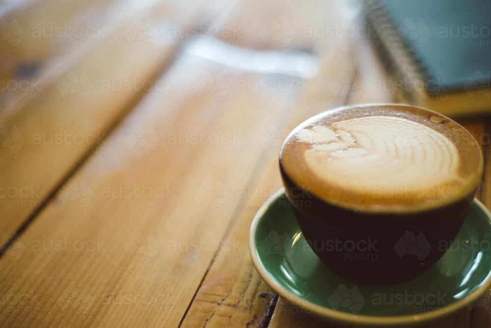 Coffee Sitting on Wooden Table - Australian Stock Image