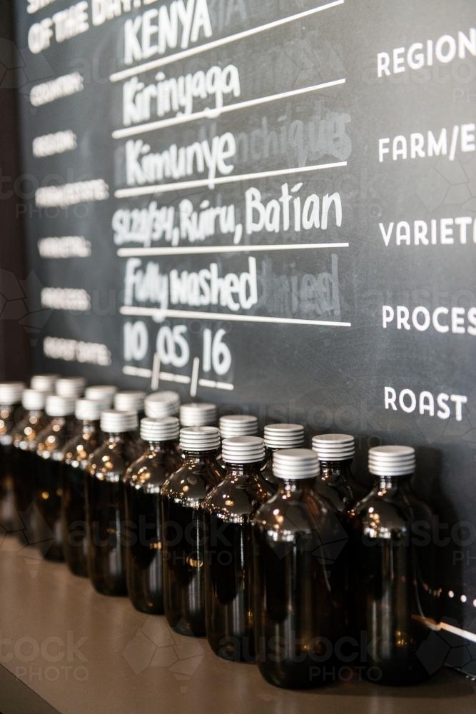 Coffee varieties on blackboard and display in a cafe - Australian Stock Image