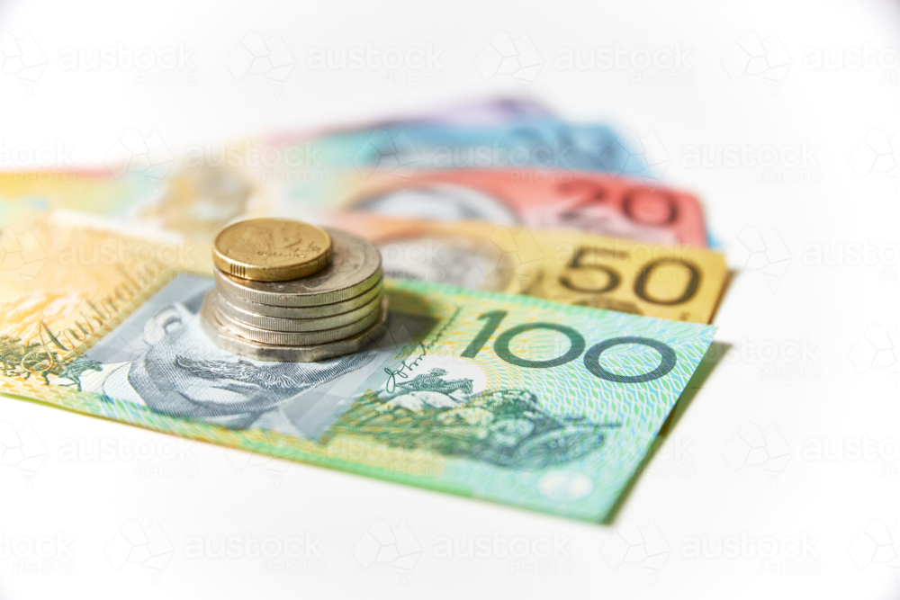 Collection of Australian banknotes and coins stack on a flat surface - Australian Stock Image
