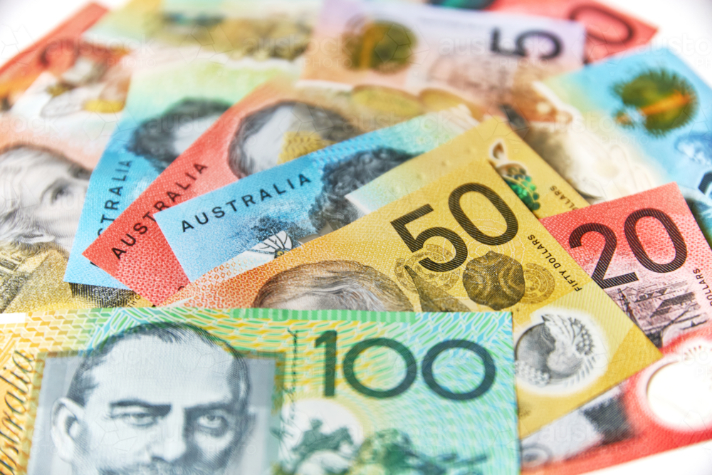 Collection of Australian banknotes scattered on a flat surface. - Australian Stock Image