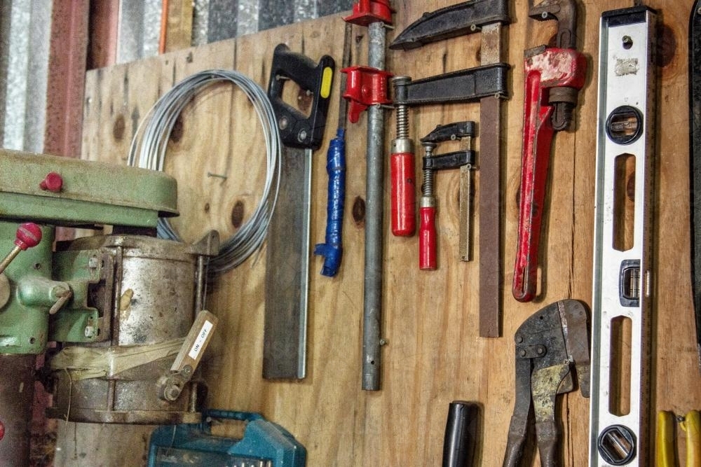 Image of Collection of tools hang on a board in the shed Austockphoto