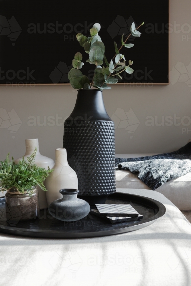 Collection of vases and ornaments on a living room ottoman - Australian Stock Image