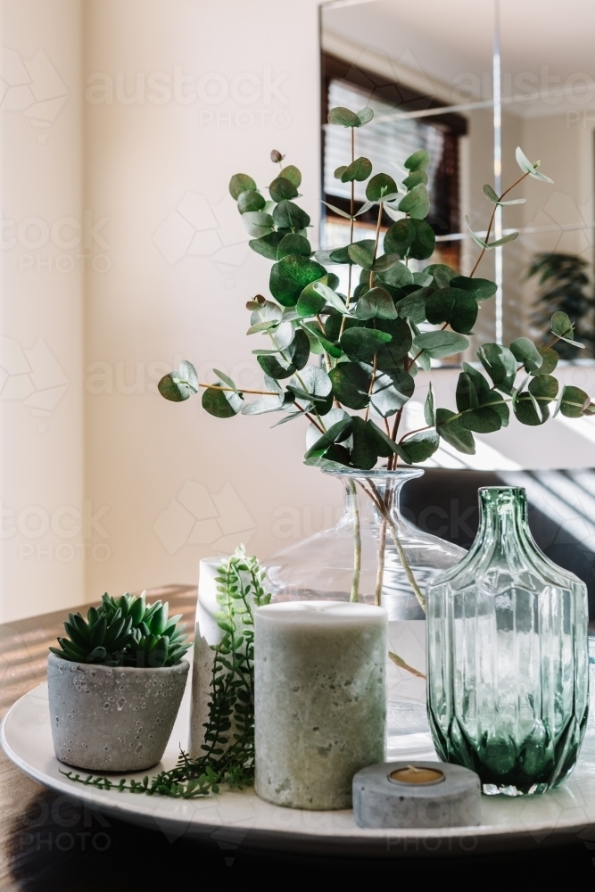 Collection of vases with greenery on a styled dining table - Australian Stock Image