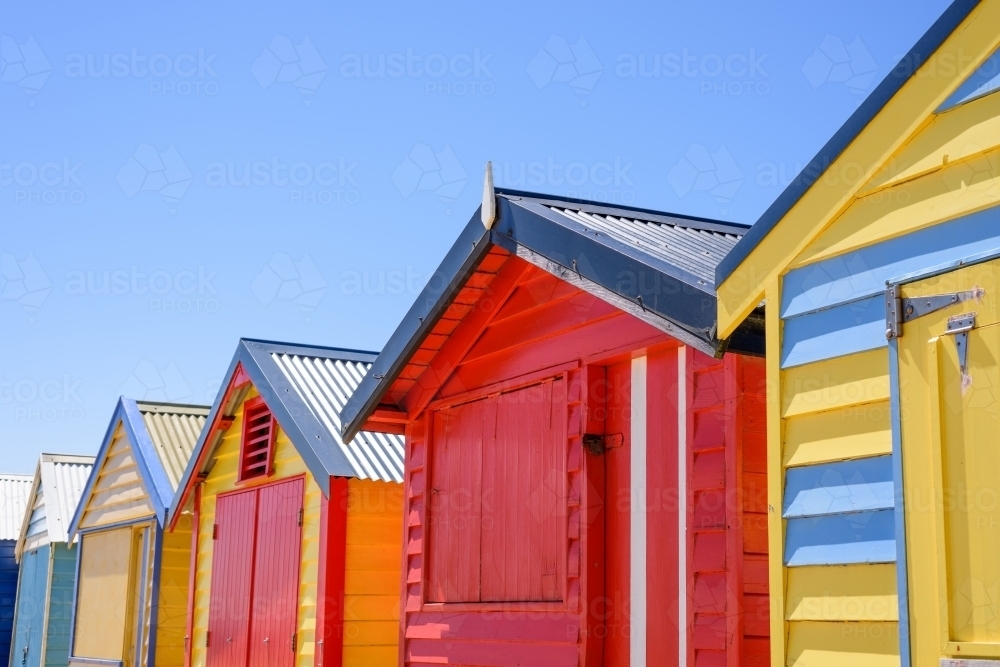 Colorful bunk houses against blue sky background. - Australian Stock Image