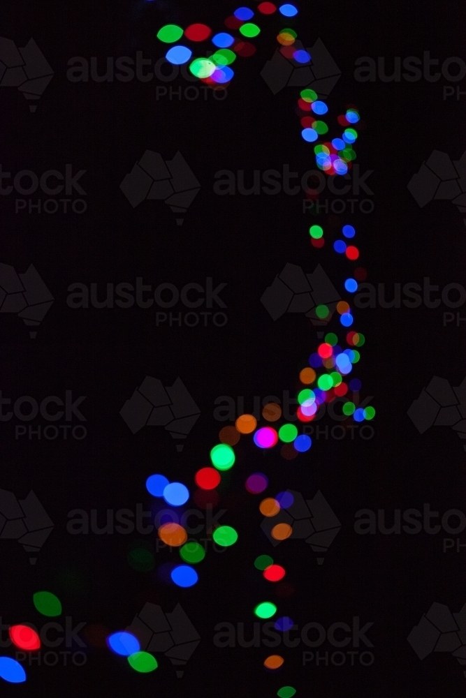 Coloured fairy lights on a black background - Australian Stock Image