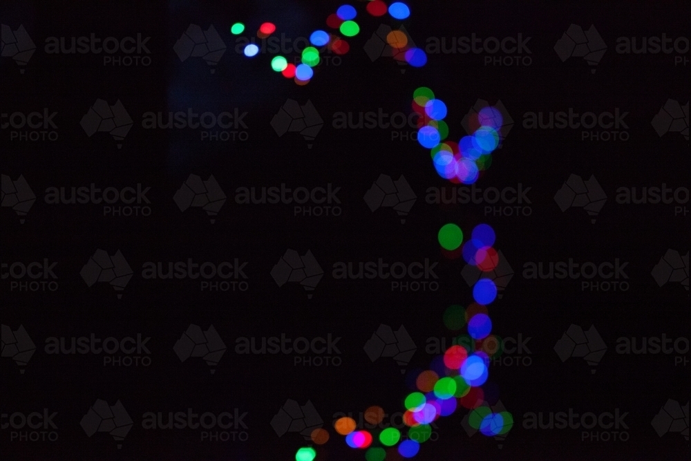 Image of Coloured fairy lights on a black background Austockphoto