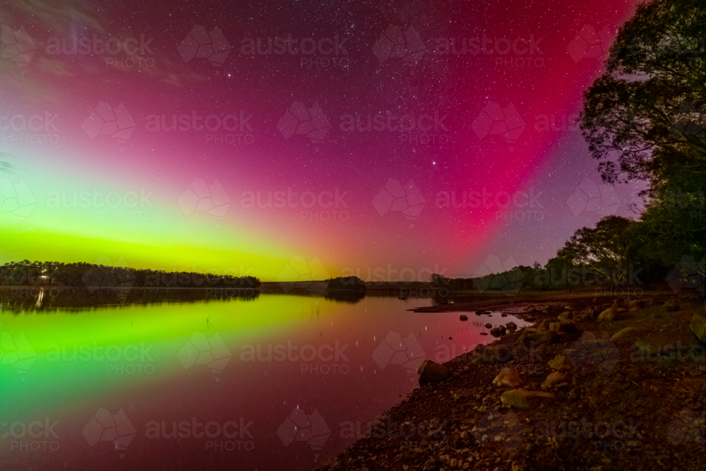 Colourful Aurora Australia reflecting in the calm waters of an inland lake - Australian Stock Image