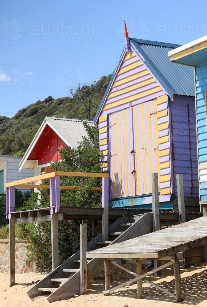 Colourful beach box with stairs leading down to the sand and sea - Australian Stock Image