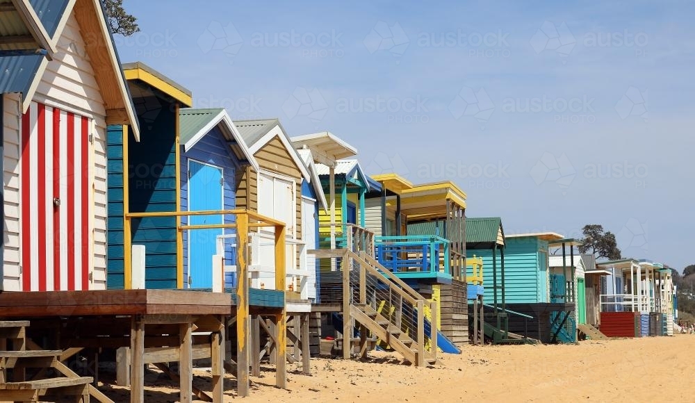 Colourful beach boxes by the seaside on a bright and sunny day - Australian Stock Image