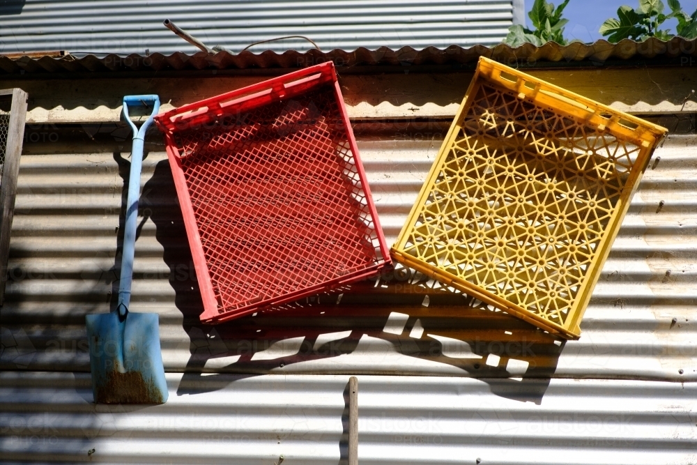 Colourful Crates Hanging on Corrugated Shed Wall - Australian Stock Image