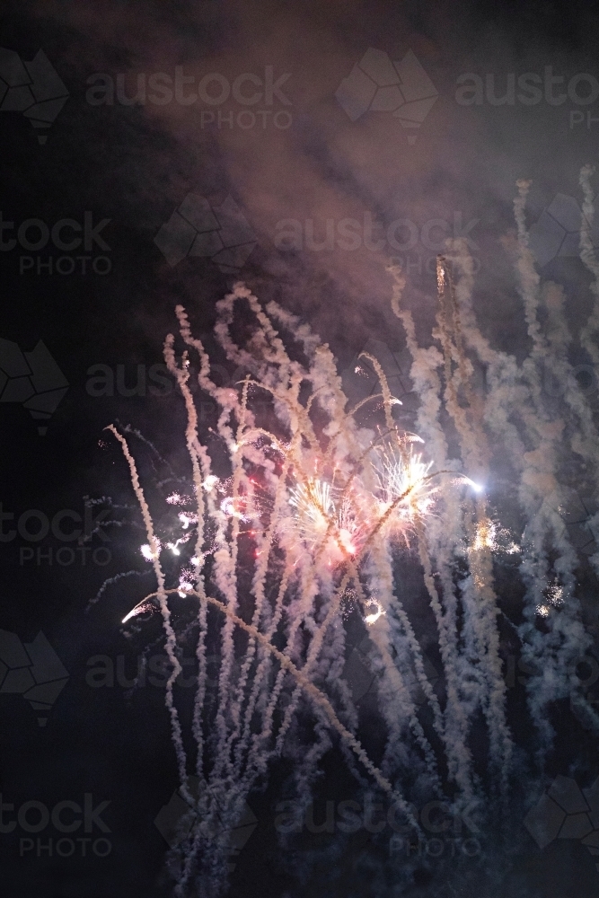 Colourful fireworks display in sky at night - Australian Stock Image