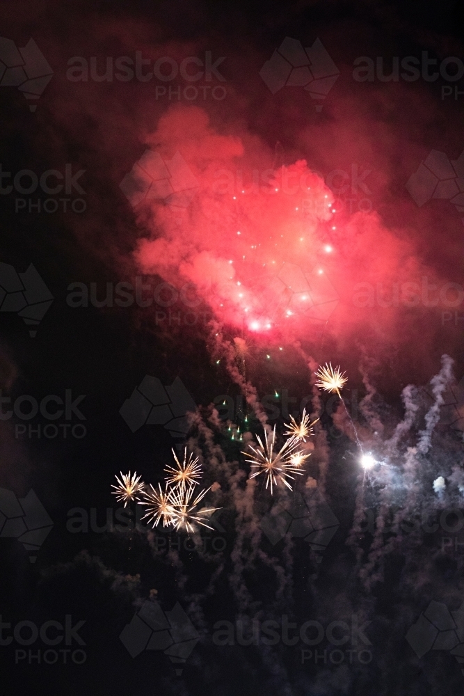 Colourful fireworks display in sky at night - Australian Stock Image