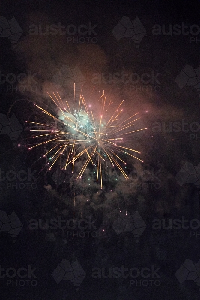 Colourful fireworks display in sky at night - Australian Stock Image