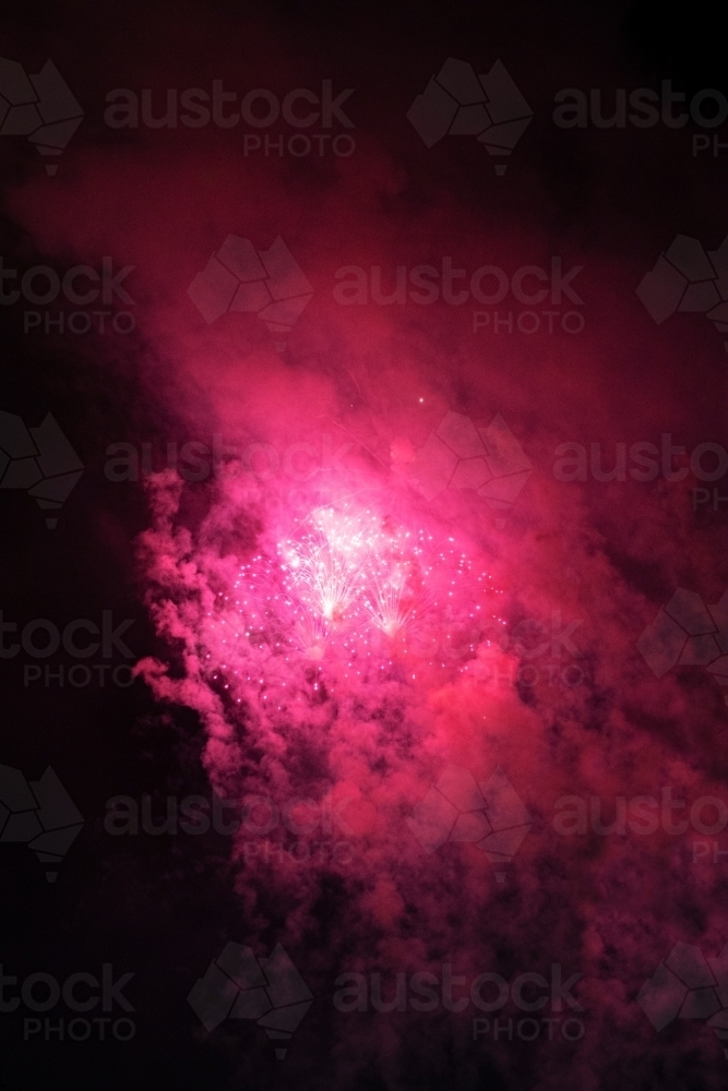 Colourful fireworks display in sky at night - Australian Stock Image
